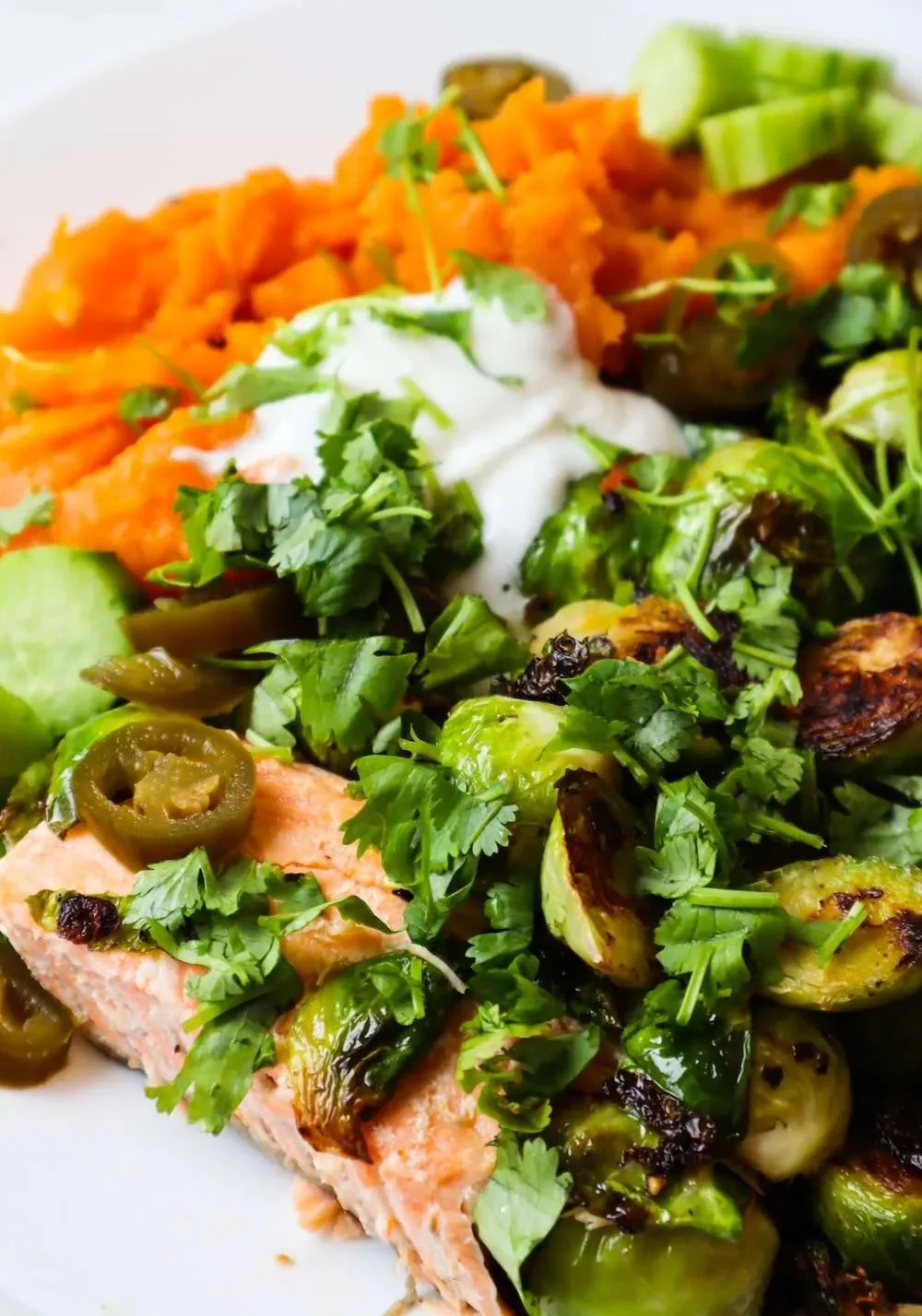 Healthy sweet potato salmon bowls with colorful veggies and toppings