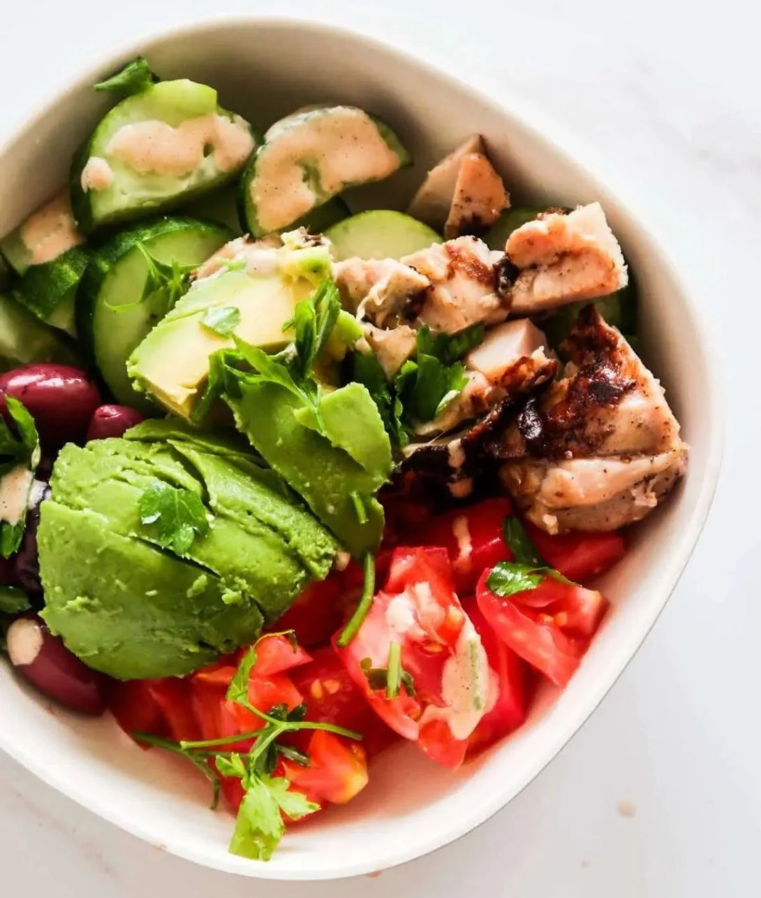 High-protein avocado chicken salad in a bowl, perfect for meal prep.