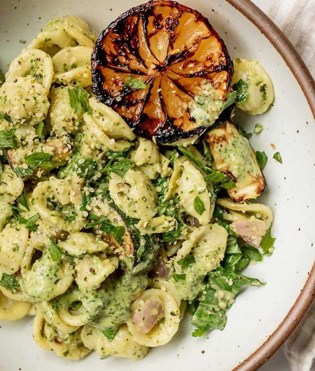 A colorful bowl of Lemon Basil Pasta Salad with fresh ingredients.