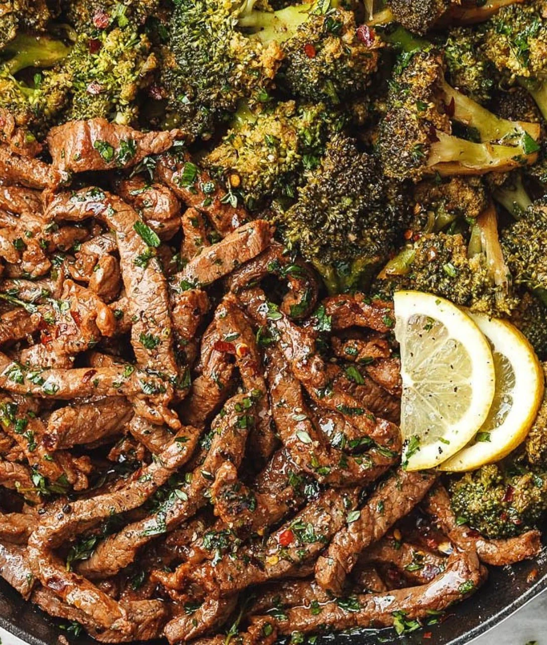 Lemon Garlic Steak cooked with broccoli in a skillet
