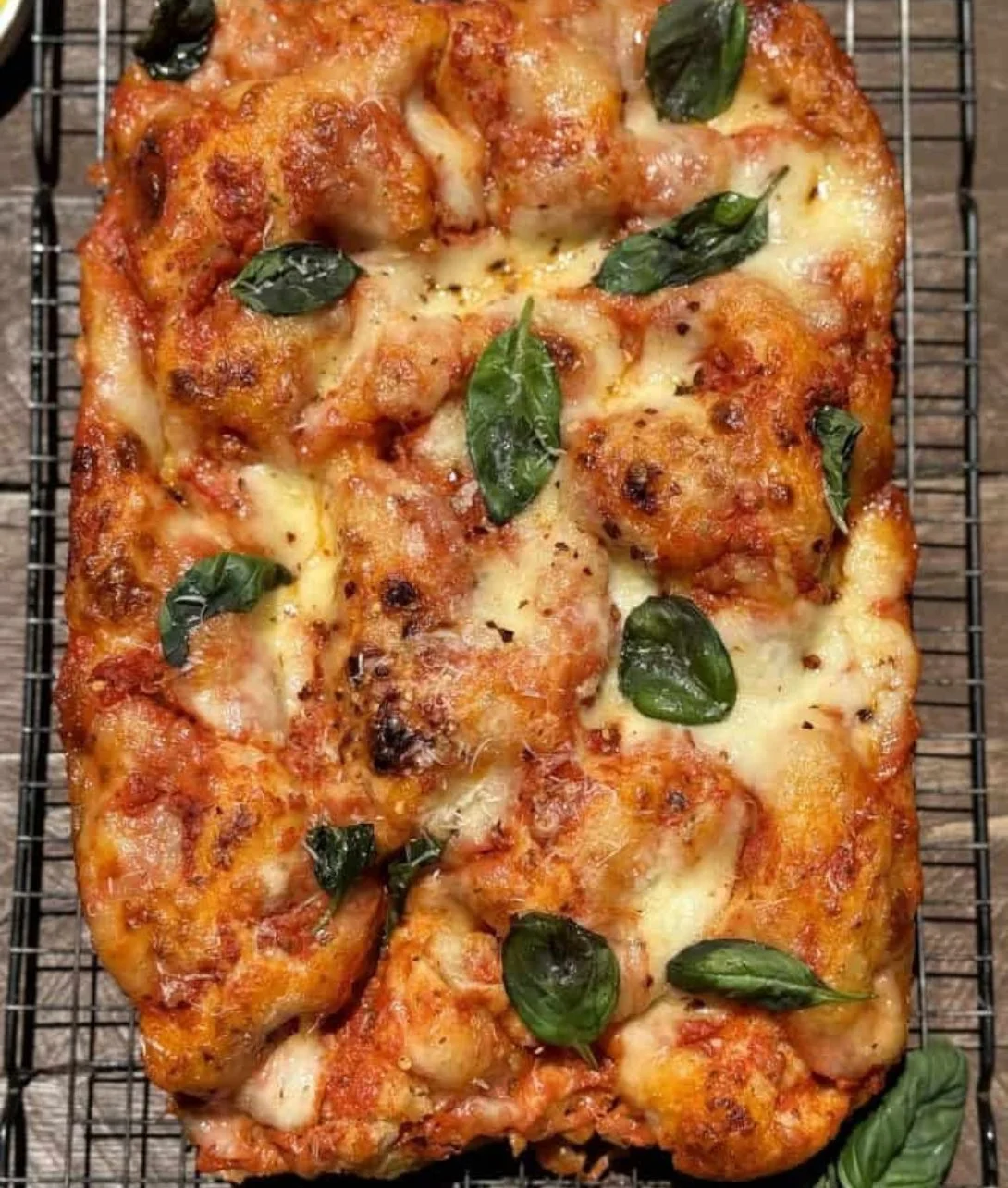 Slice of Margherita Pizza Focaccia topped with fresh mozzarella and basil