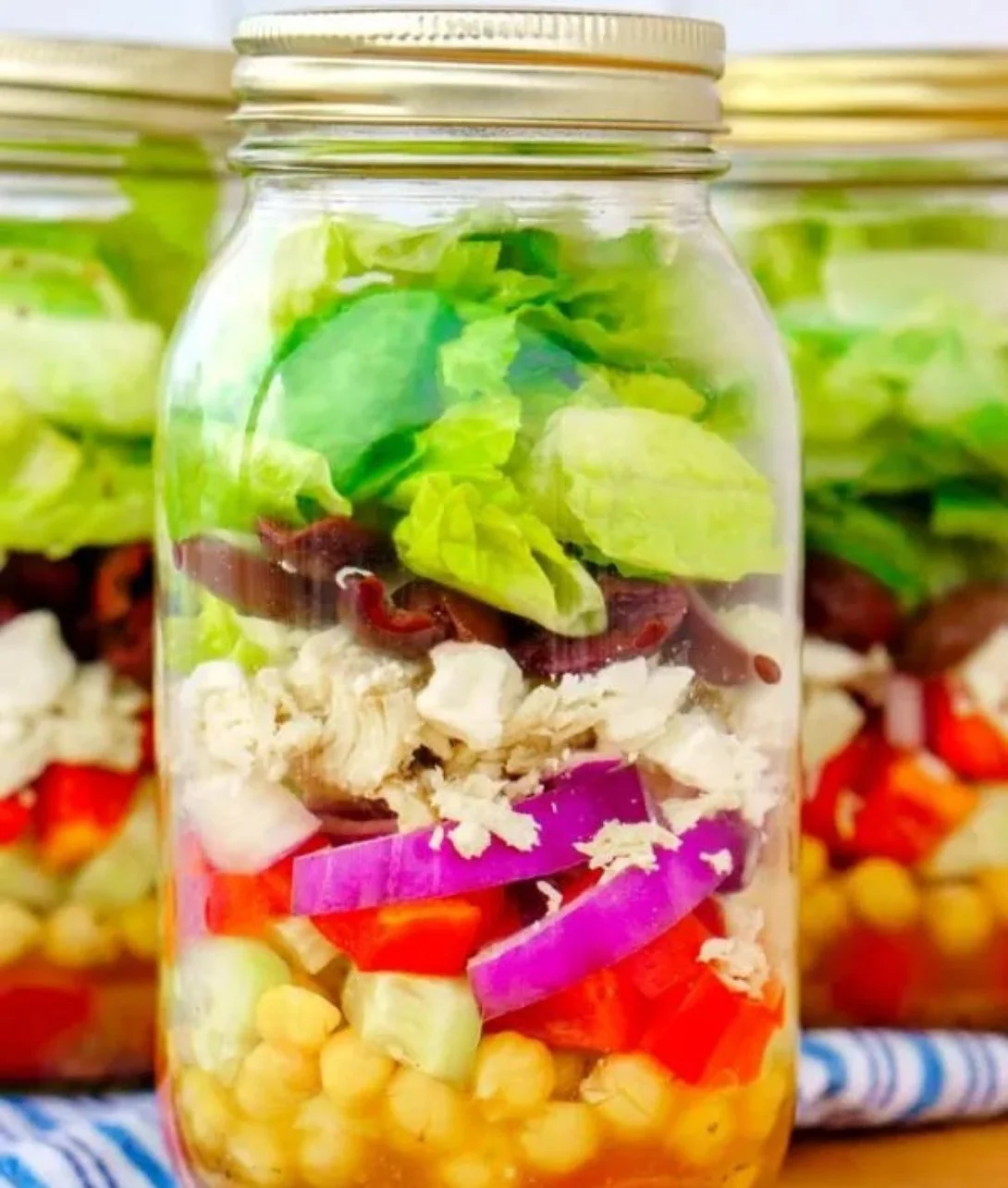 Mason Jar Greek Salad Jars with fresh vegetables and dressing