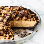 Deliciously layered Peanut Butter Pie with chocolate topping and whipped cream.