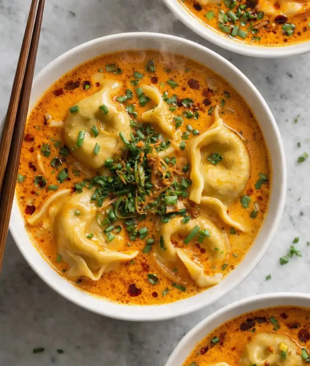 Bowl of quick coconut curry soup topped with fresh herbs and spices.