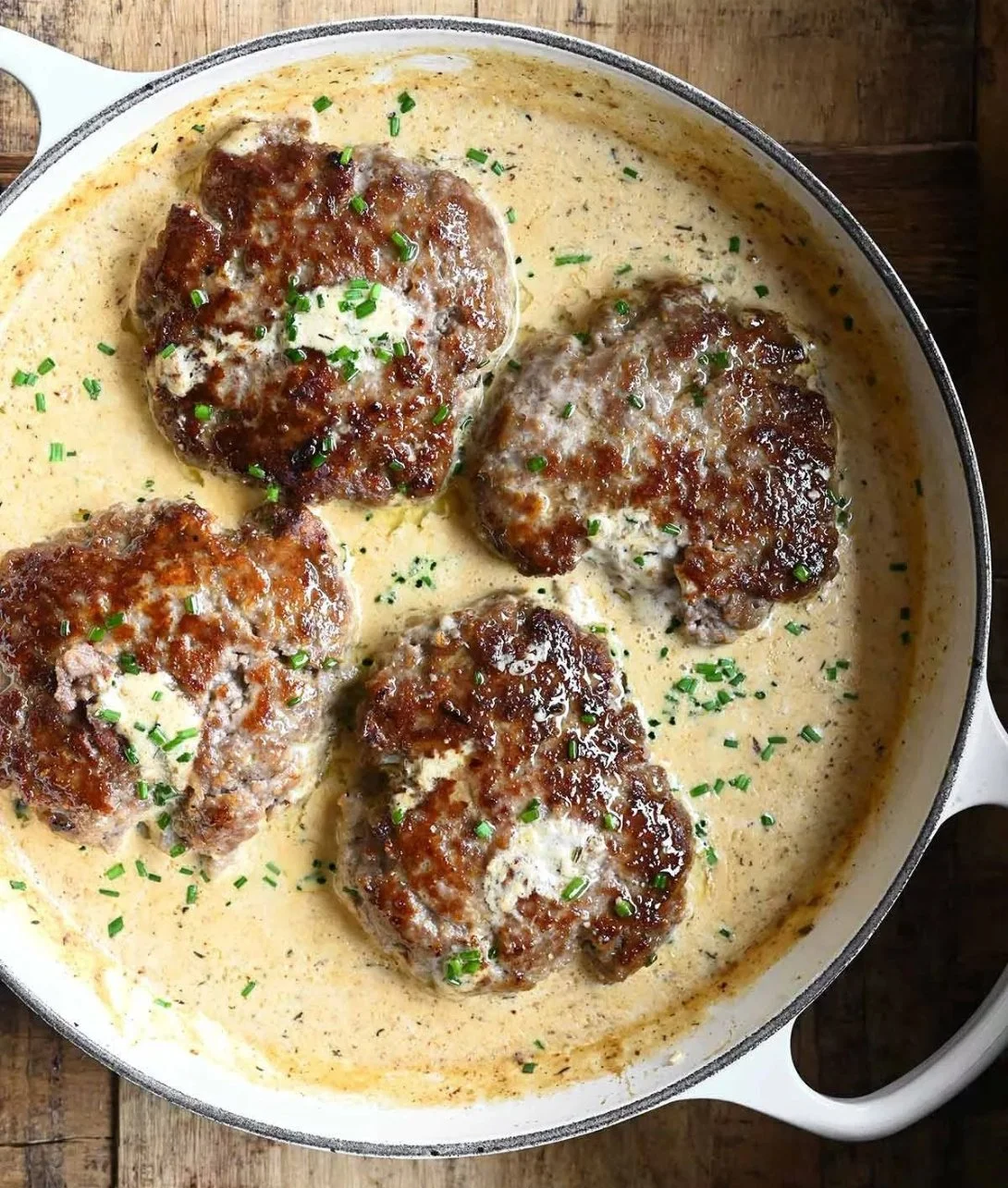 Salisbury steaks in horseradish parmesan sauce served with vegetables