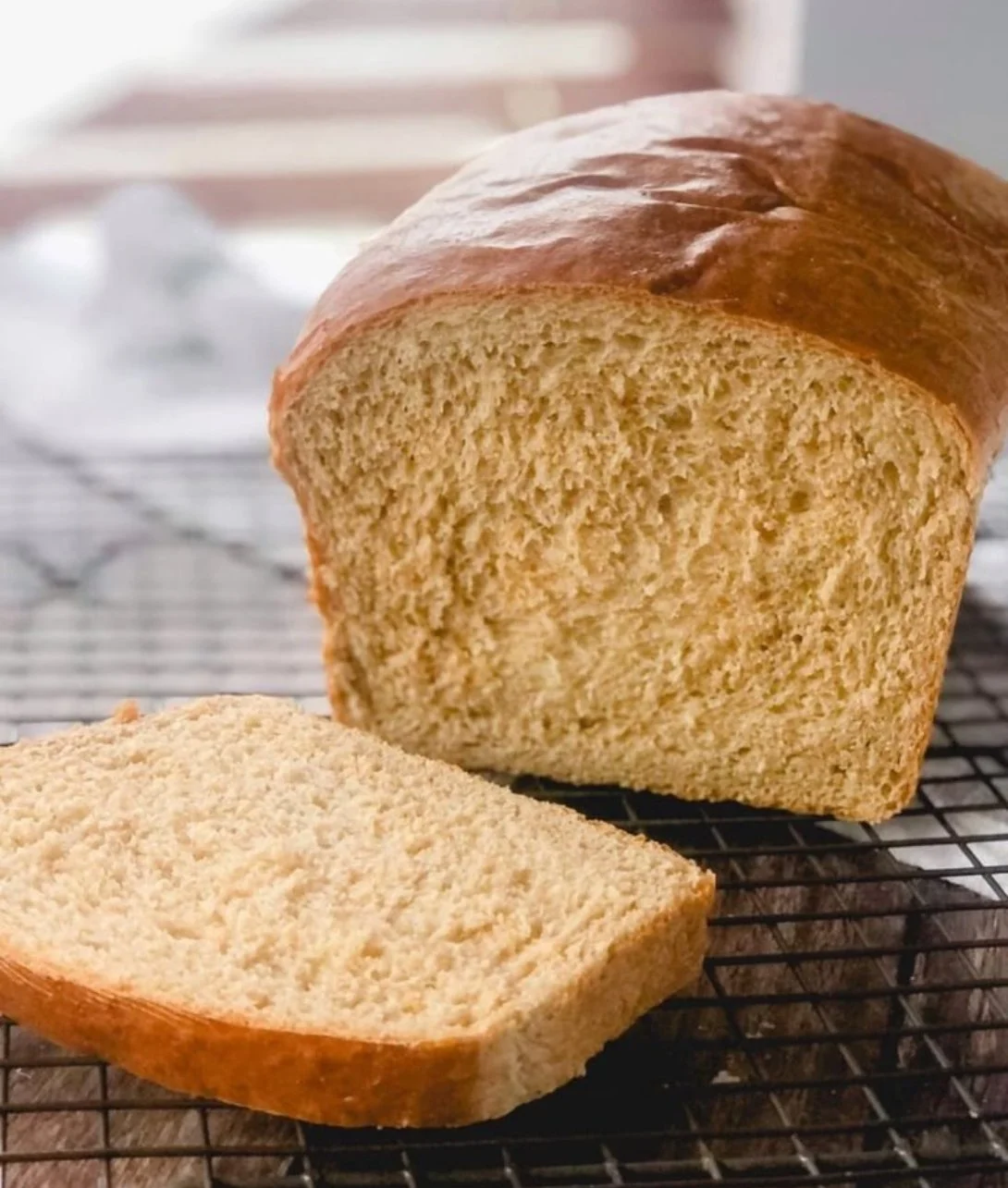 Loaf of fresh homemade honey wheat bread on a kitchen countertop