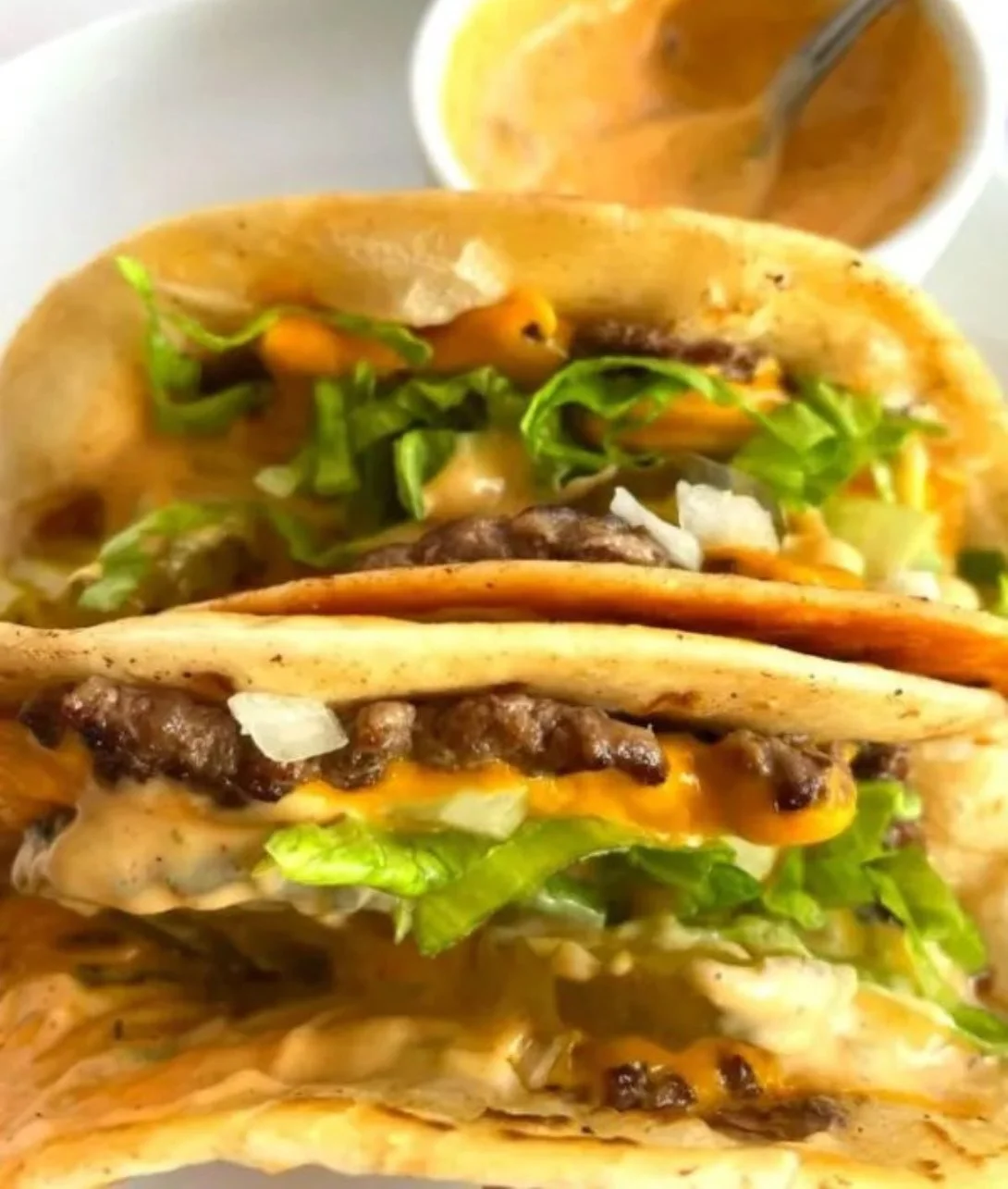 Smash burger tacos with juicy beef and fresh toppings in crispy tortillas
