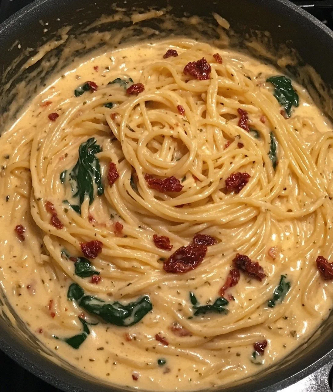 Delicious spaghetti spinach with sun-dried tomato cream sauce served in a bowl