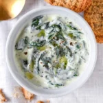 Delicious homemade spinach dip served in a bowl with fresh vegetables