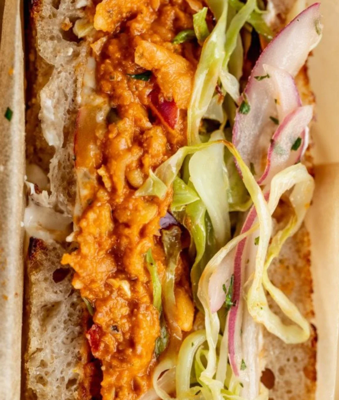 Sun-Dried Tomato Romesco Chickpea Salad Sandwich on a plate