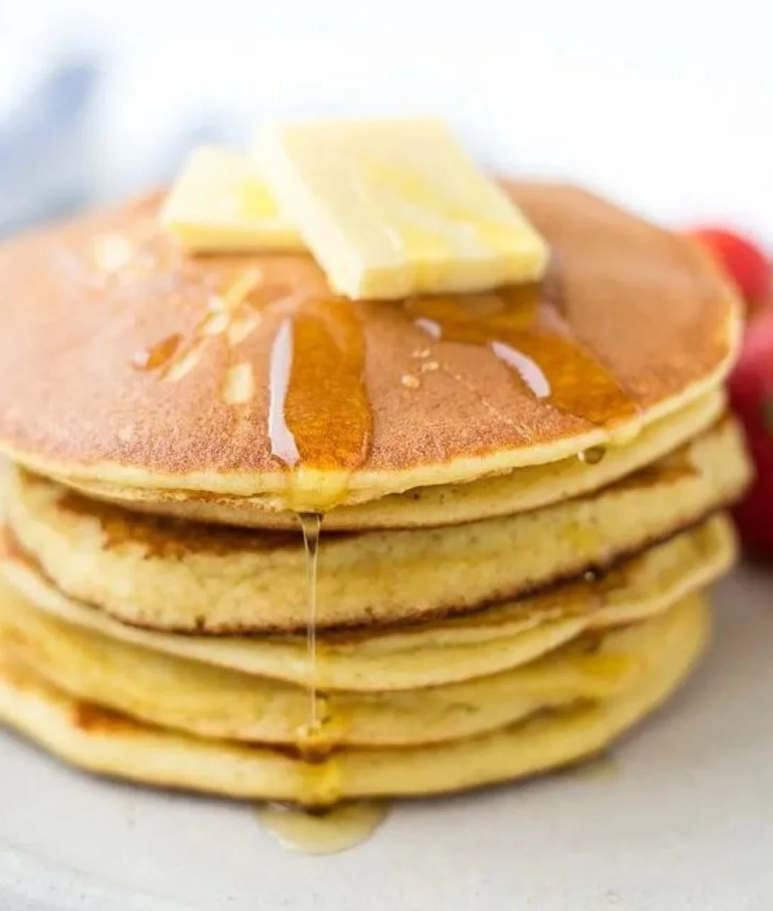 Fluffy and delicious keto pancakes served with fresh berries and syrup.