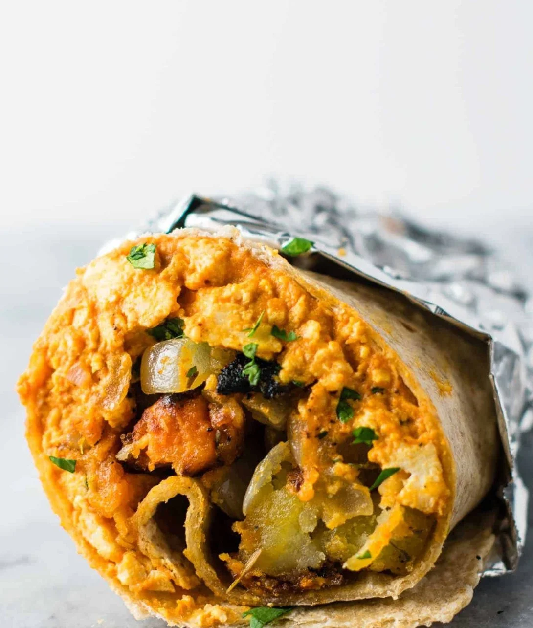 Delicious vegan breakfast burrito filled with fresh veggies and spices