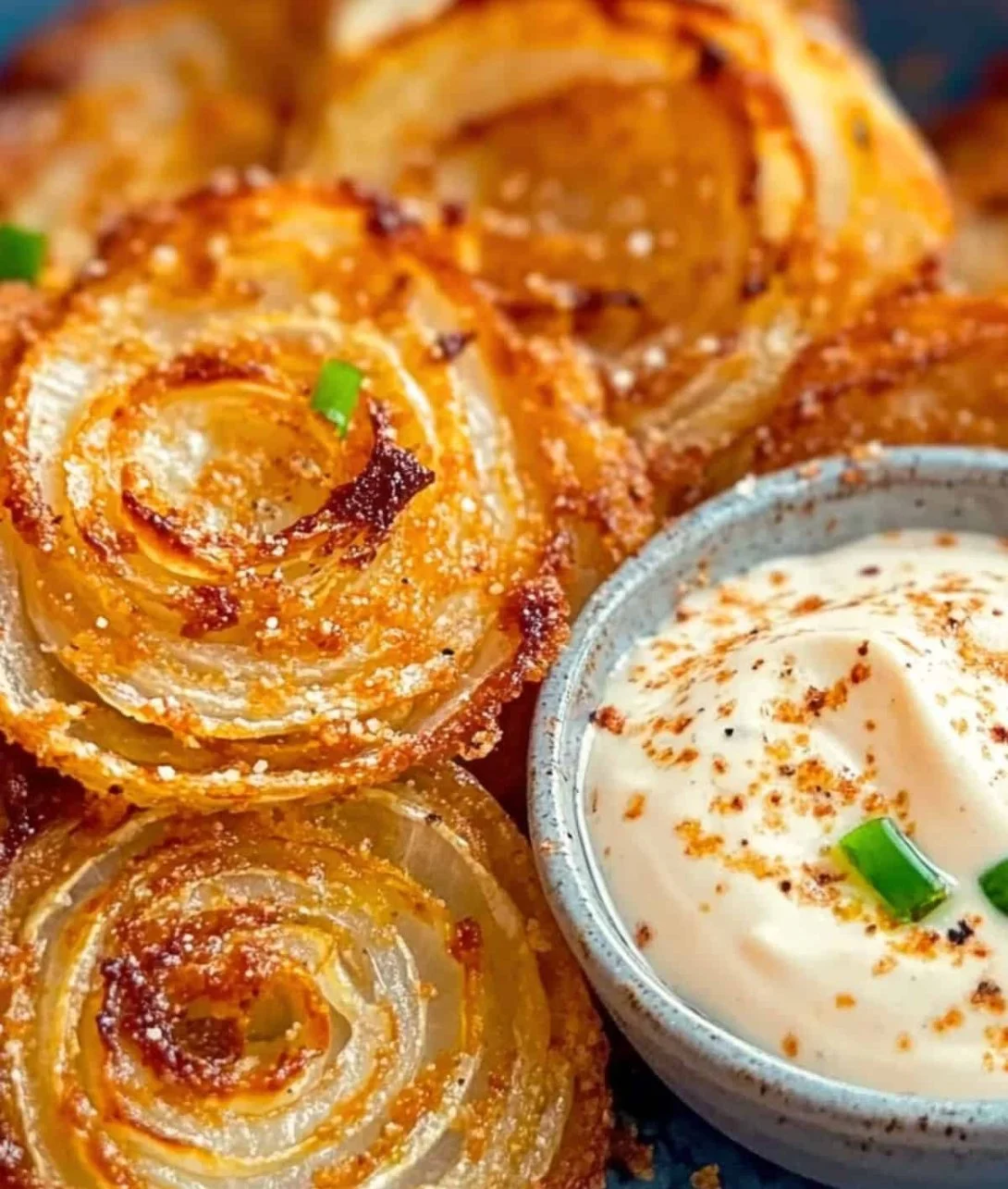 Crispy viral Parmesan Onion Rings served on a plate, garnished and ready to enjoy.
