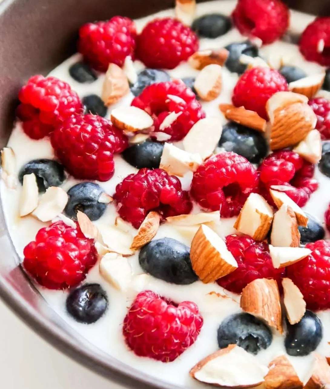 Bowl of yogurt with fresh berries and nuts for a nutritious snack