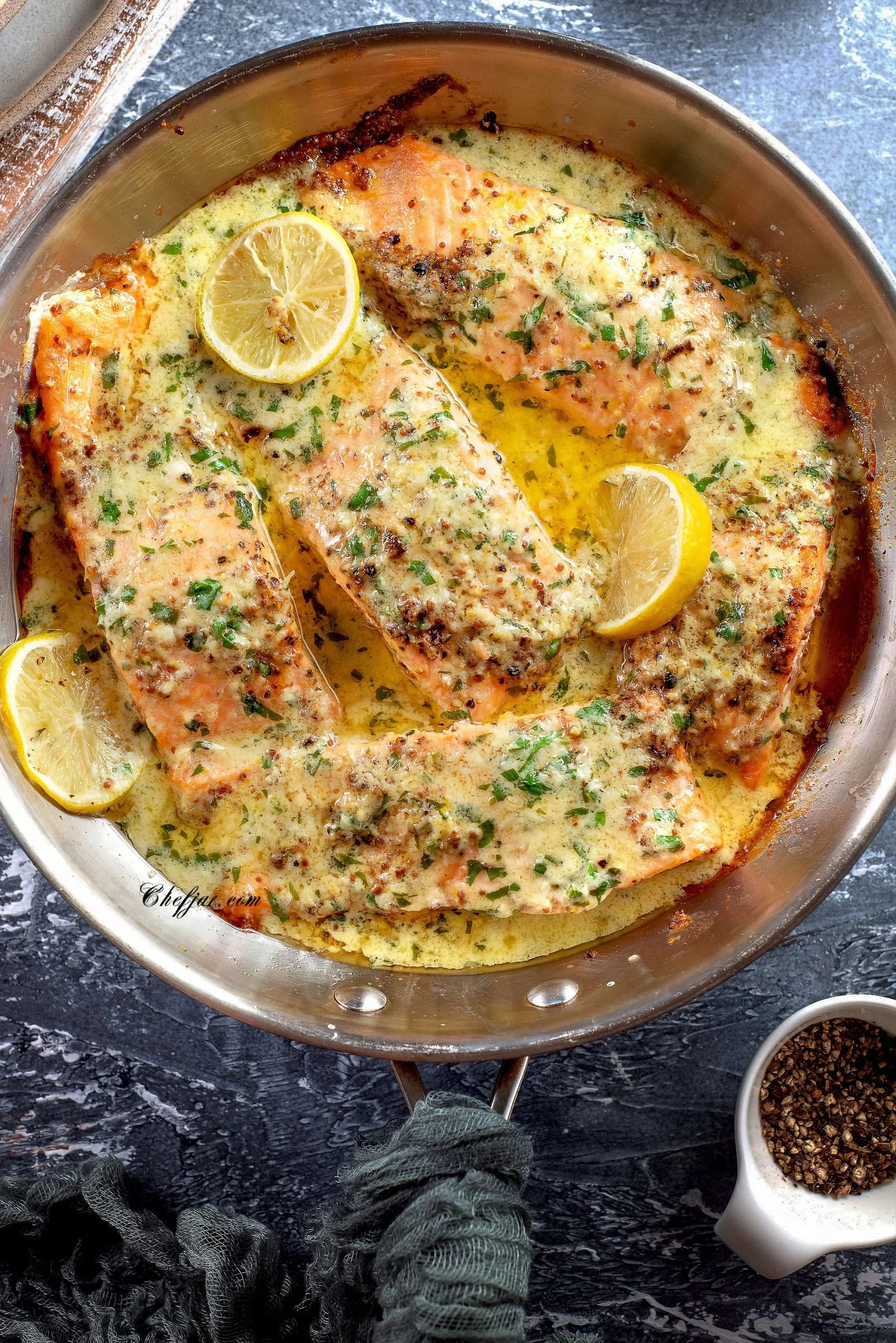 Baked salmon fillets topped with lemon butter cream sauce