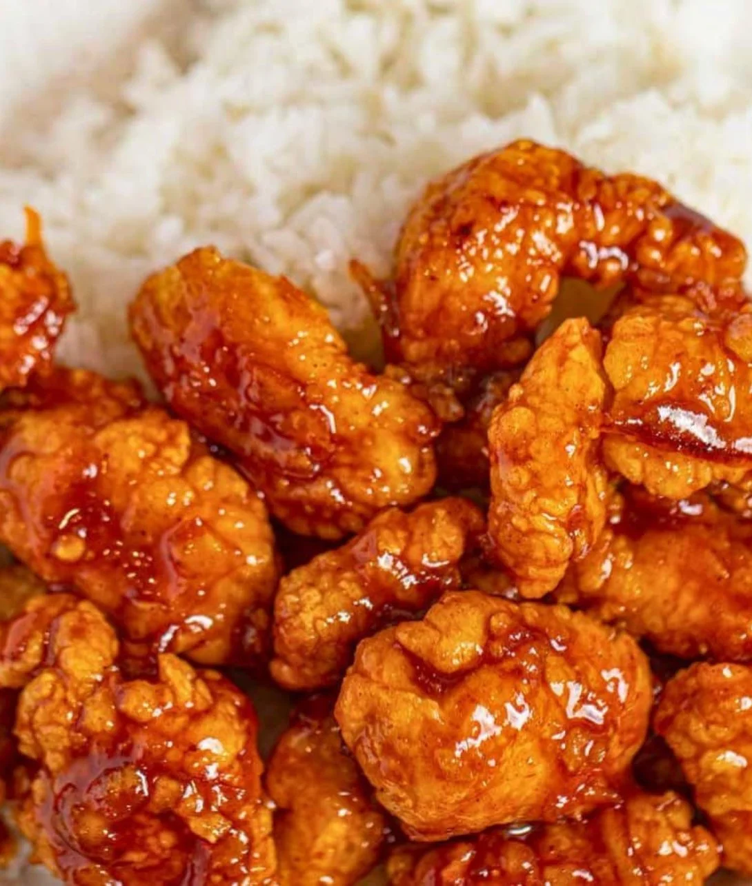 Easy three-ingredient orange chicken served in a bowl with rice