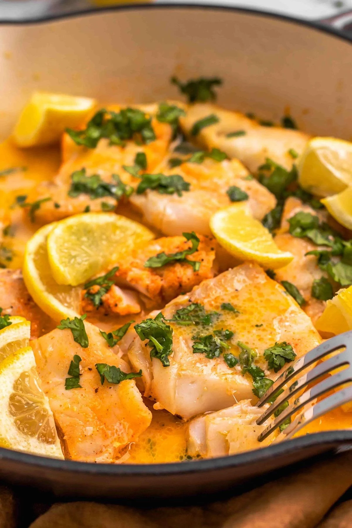 Delicious buttered cod fillet served on a plate with garnishes