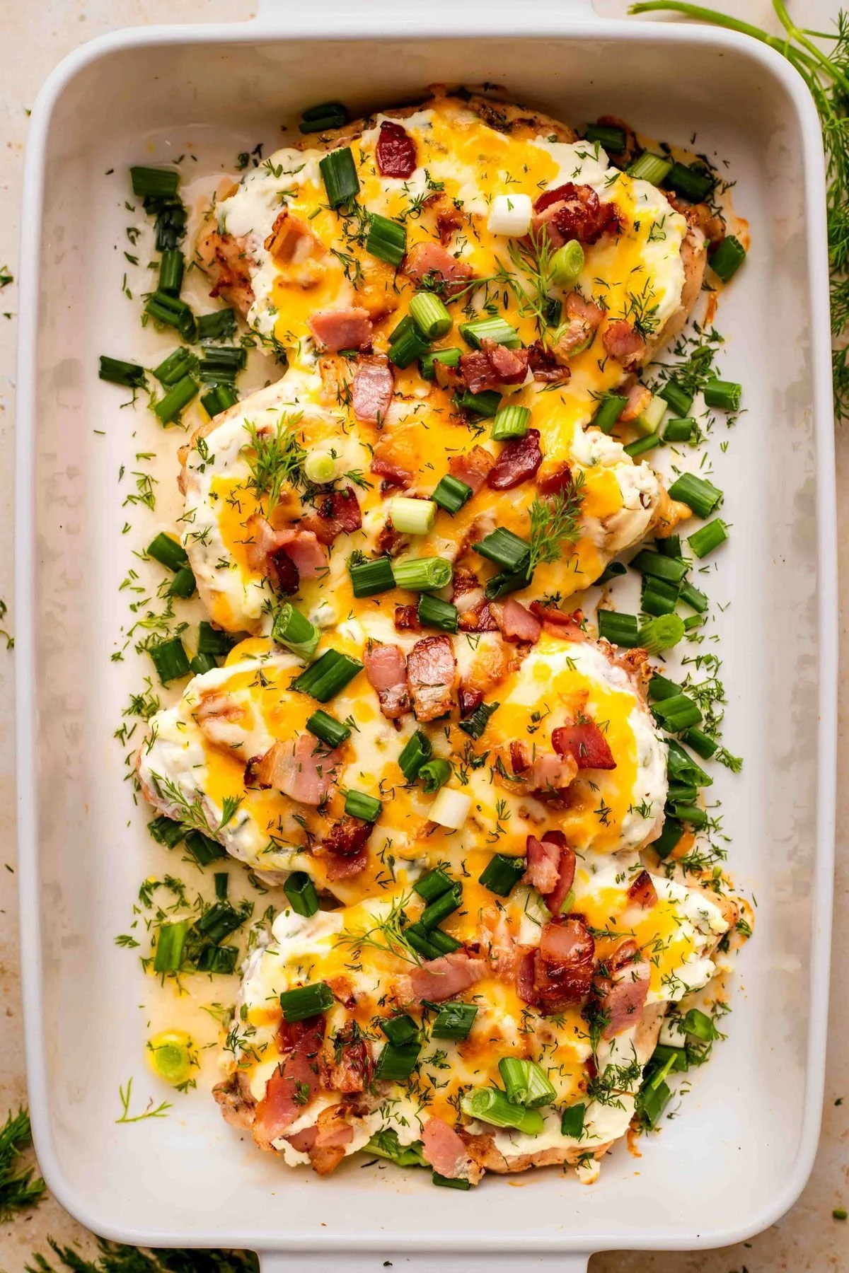 Delicious Crack Chicken Bake topped with cheese and herbs ready to serve.