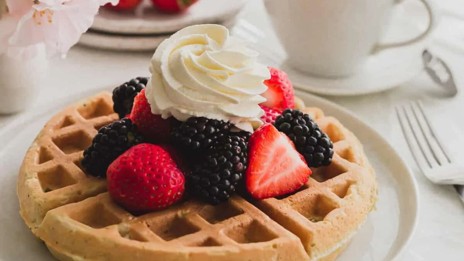 Earl Grey infused waffles topped with fresh berry medley on a plate