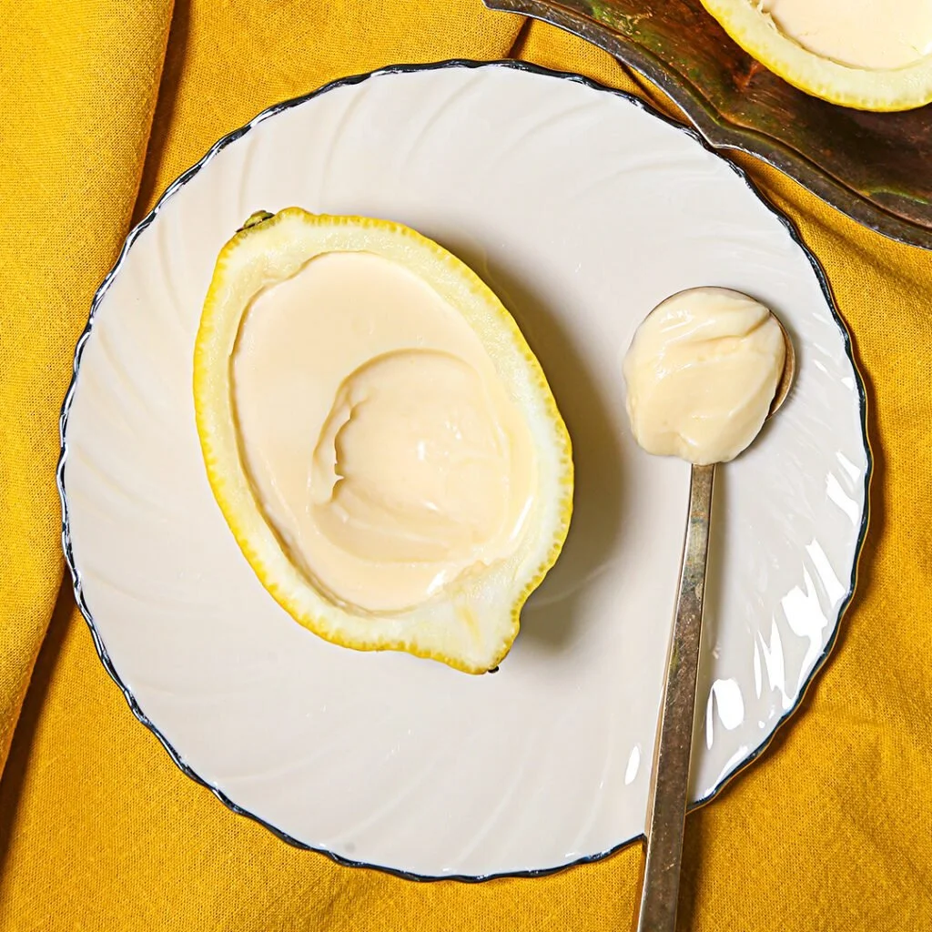 Easiest-ever lemon pudding served in a glass dish with a lemon slice