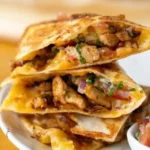 Delicious easy chicken quesadillas served on a plate with toppings