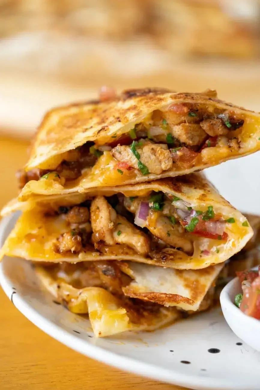 Delicious easy chicken quesadillas served on a plate with toppings