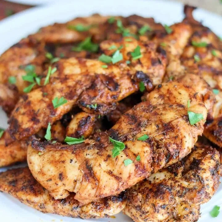 Juicy grilled chicken tenderloins served with fresh herbs and lemon slices