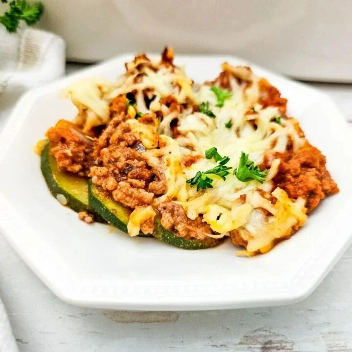 Ground beef and zucchini casserole in a baking dish topped with cheese
