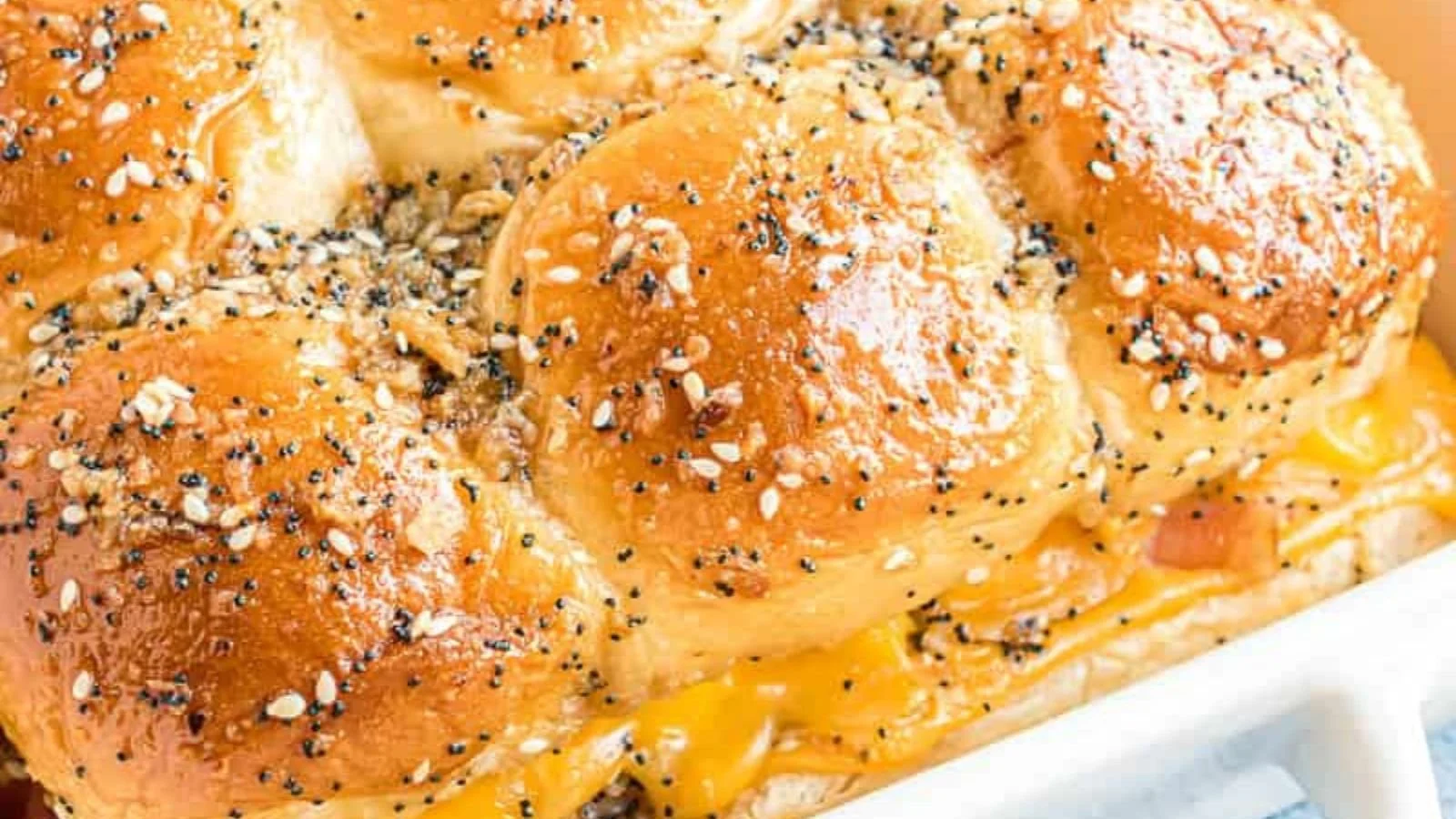 Hawaiian Roll Breakfast Sliders with eggs, cheese, and ham on a platter.