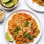 Delicious Instant Pot Chicken Pad Thai served in a bowl with fresh herbs.