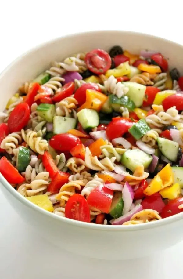 Colorful Italian Pasta Salad with fresh vegetables and dressing on a plate
