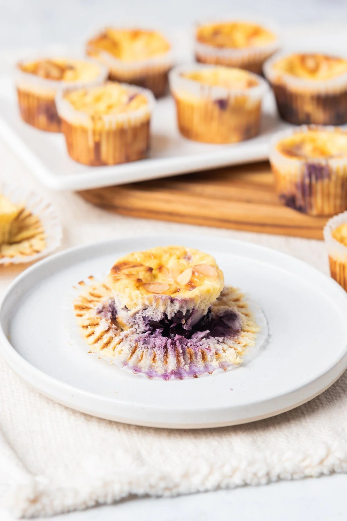 Keto Blueberry Cream Cheese Muffins on a rustic wooden table