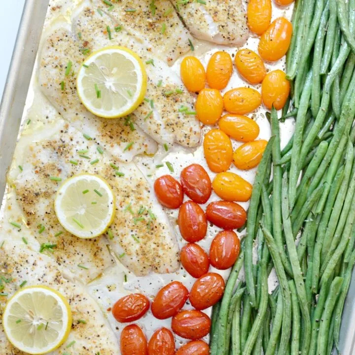 Delicious lemon pepper tilapia served on a sheet pan with vegetables.