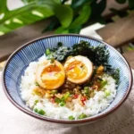 Mayak Eggs served on a plate garnished with herbs and colorful vegetables