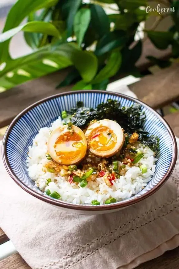 Mayak Eggs served on a plate garnished with herbs and colorful vegetables