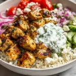 Mediterranean Lemon Chicken Bowl topped with fresh dill and colorful vegetables
