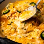 One-Pan Cheesy Jalapeno Chicken garnished with jalapenos and cheese.