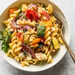Delicious roasted veggie pasta with feta cheese served in a bowl