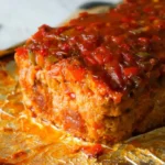 Sliced Sausage and Peppers Meatloaf served with garnish.