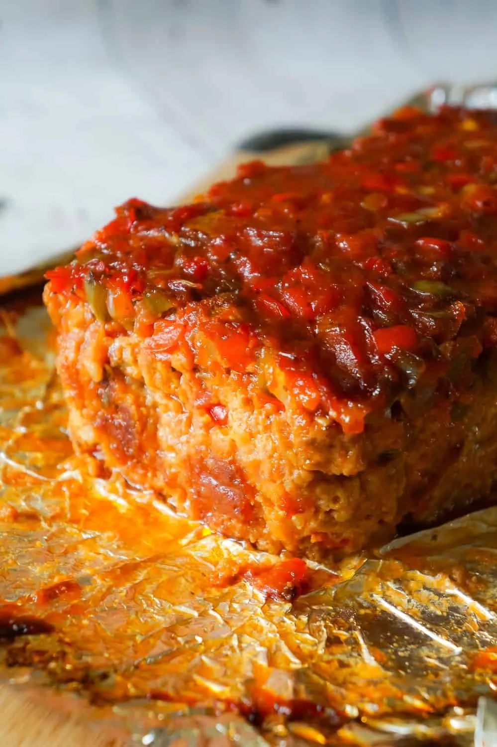 Sliced Sausage and Peppers Meatloaf served with garnish.