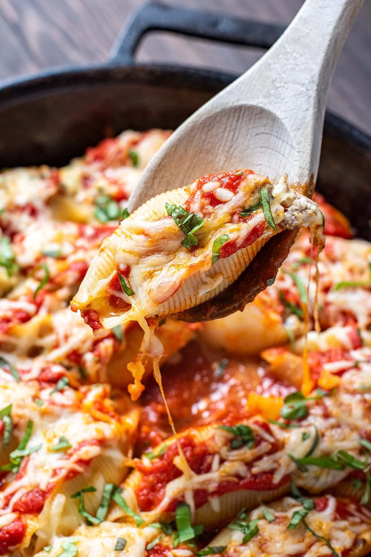 Plate of sausage stuffed shells topped with marinara sauce and cheese