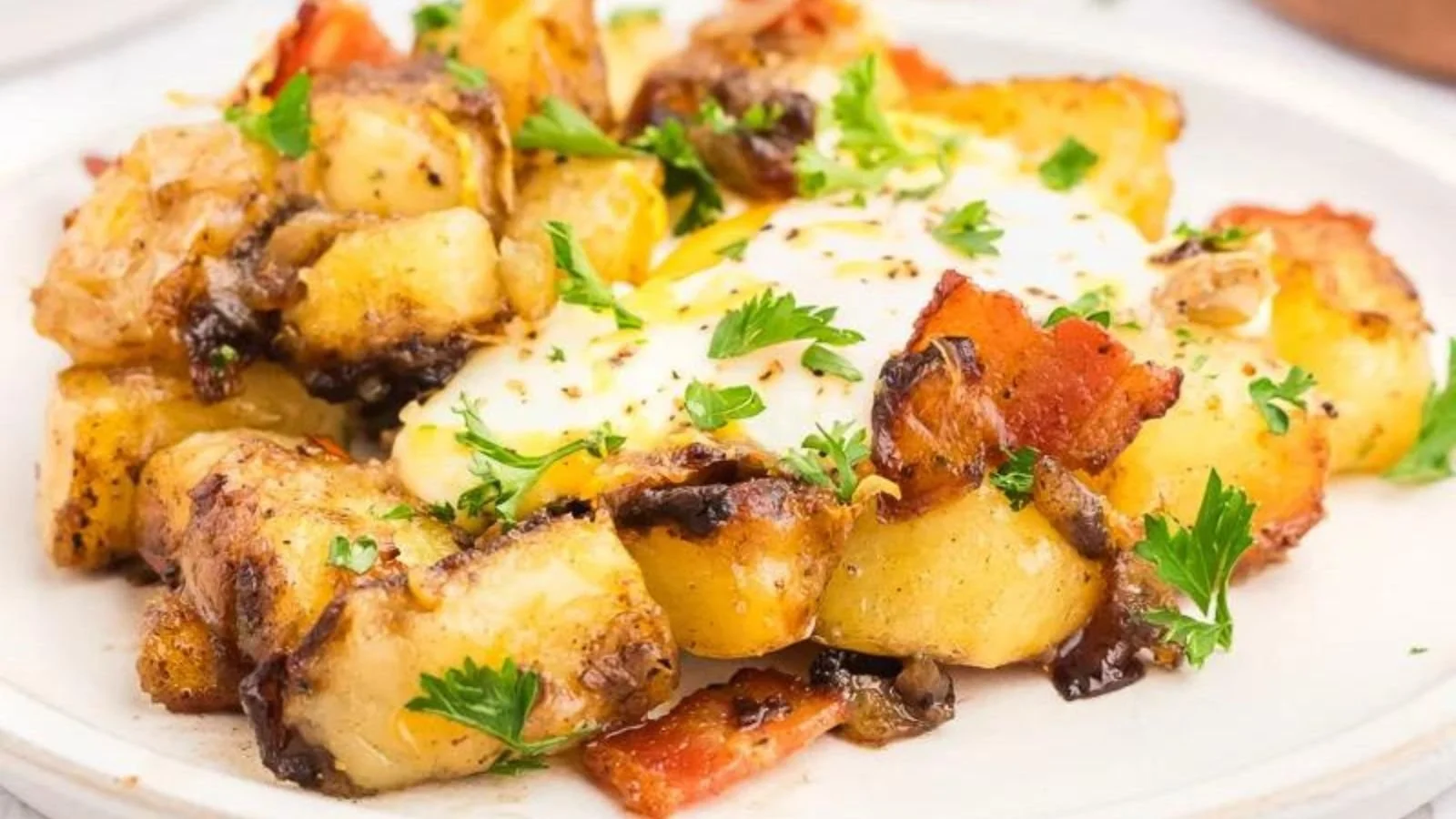 Delicious breakfast hash with potatoes, eggs, and vegetables in a skillet.
