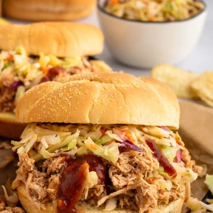 Delicious slow cooker BBQ chicken served with a side of coleslaw.