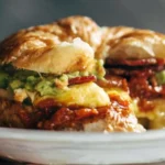 Ultimate breakfast sandwich with eggs, cheese, and bacon on a toasted bun