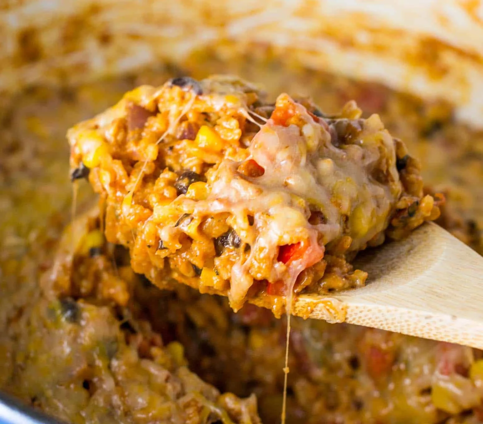 Vegetarian Mexican casserole topped with cheese and fresh herbs